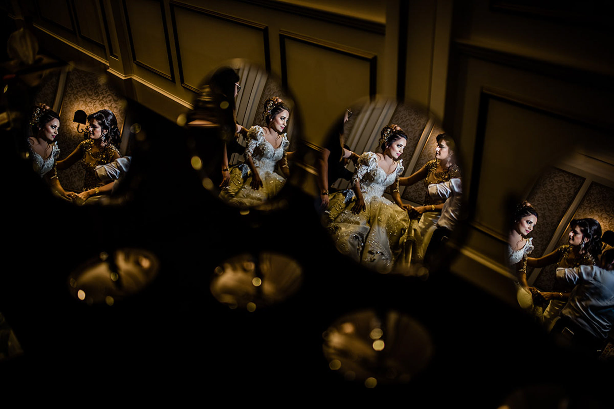 Bride in beaded gown reflected in four mirrors by Rimi Sen 